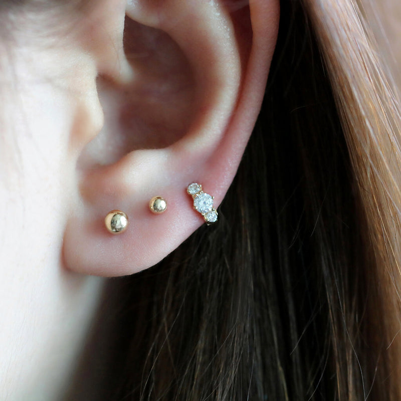 tiny diamond huggie hoop earring in third lobe piercing