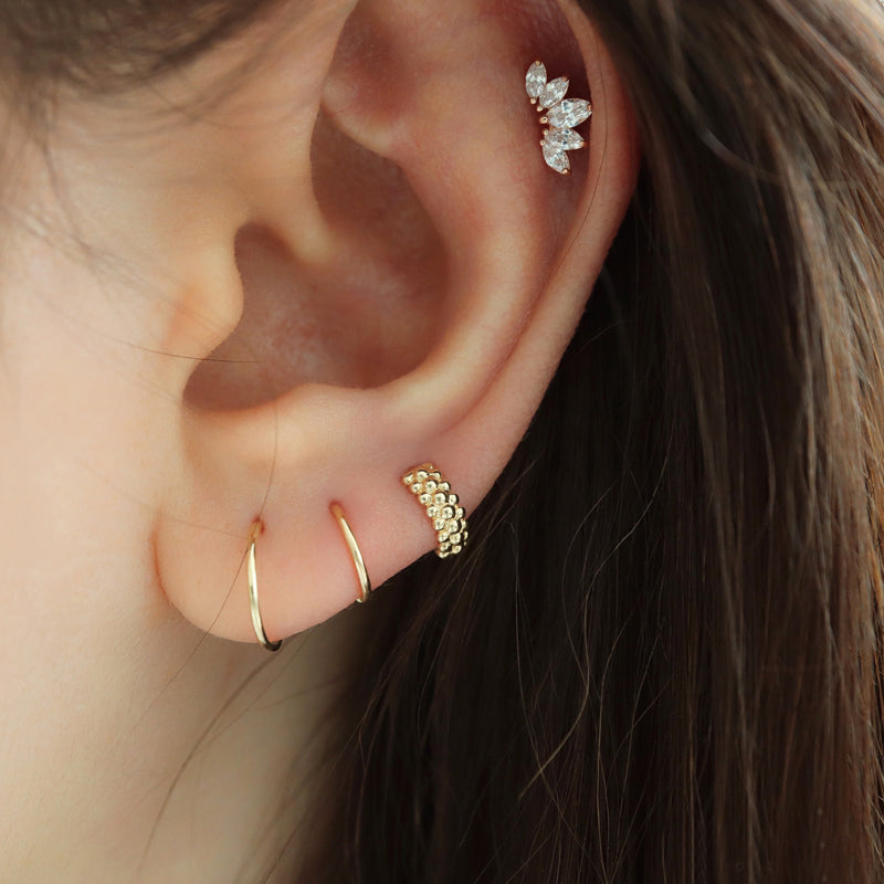 stacked huggie hoop earrings in triple lobe piercing