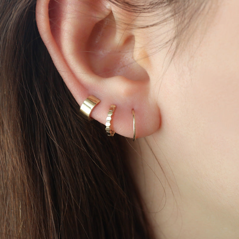 small wide huggie hoop earring in third lobe piercing