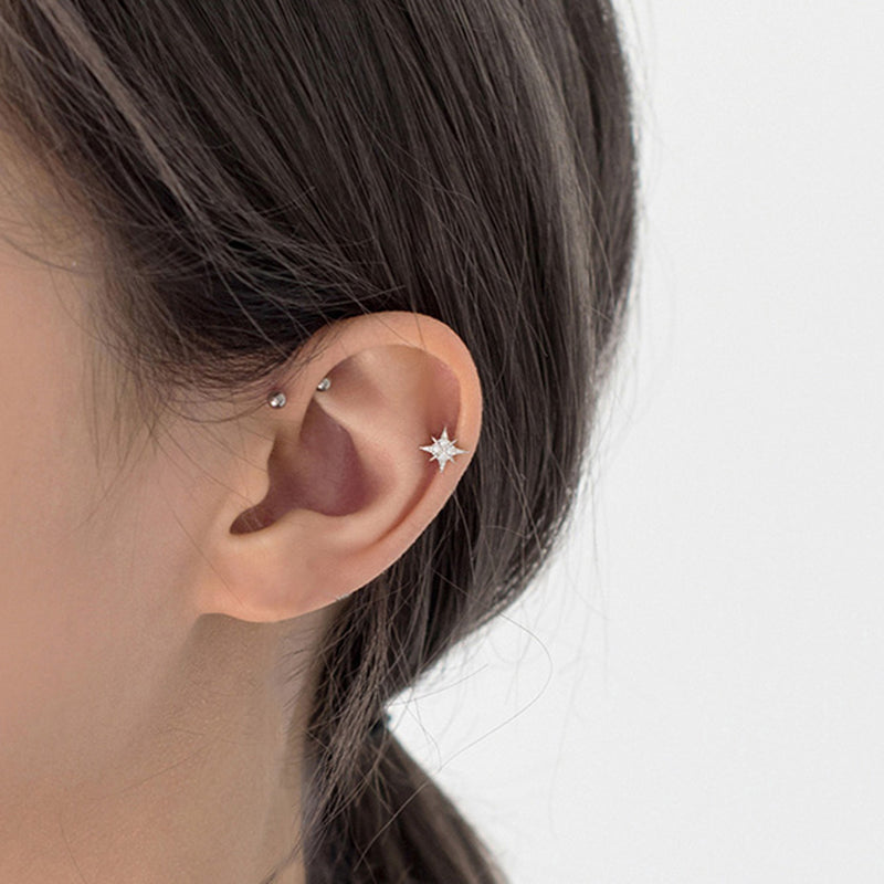 north star earrings on cartilage piercing