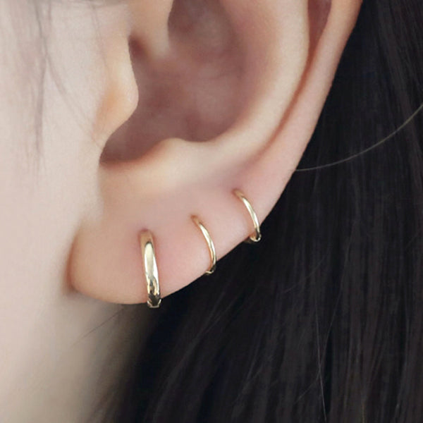 Small thin huggie hoop earrings in 14k gold