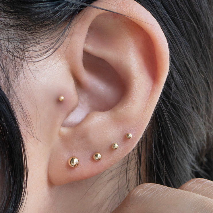 ball stud flat back ear piercings stacked in ear lobe and cartilage