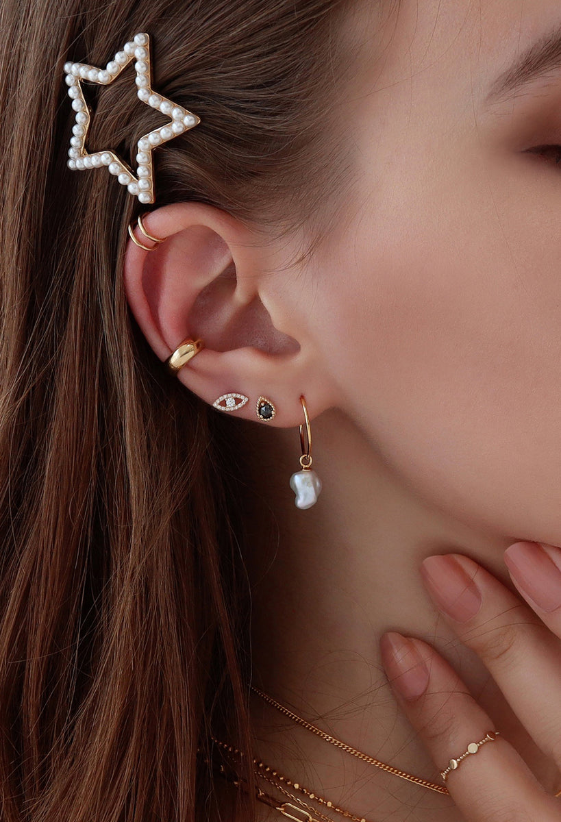 Curated ear stacks with pearl and gold piercings