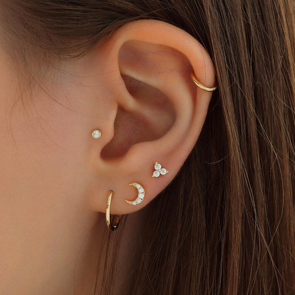dainty stacked ear piercings in solid gold