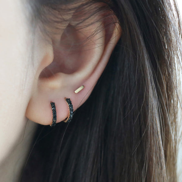 black diamond huggie hoop earrings in double lobe piercings