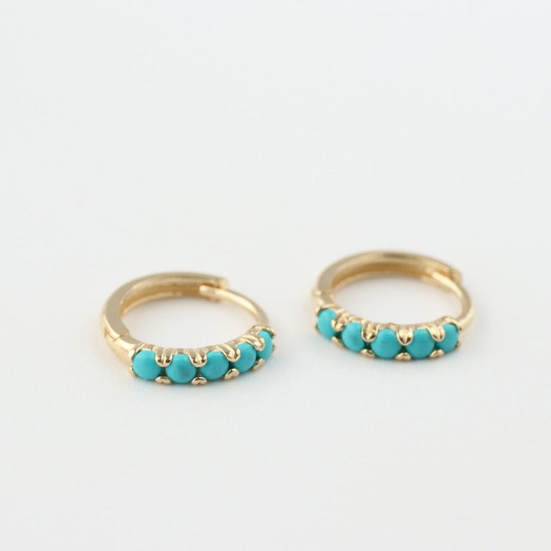 14k gold huggie hoops earring featuring turquoise stones