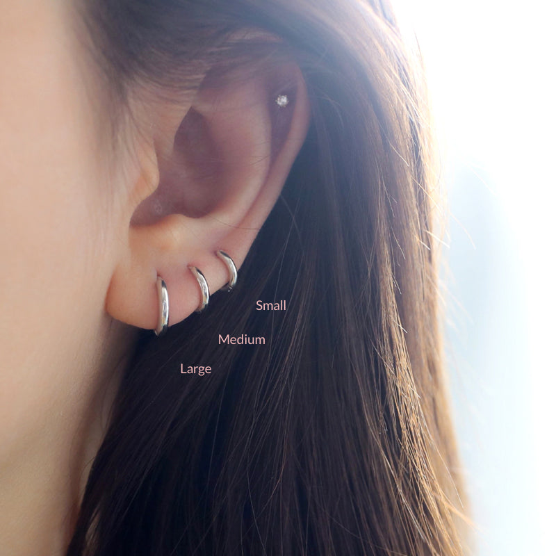 stacked triple hoop earrings in triple lobe piercings