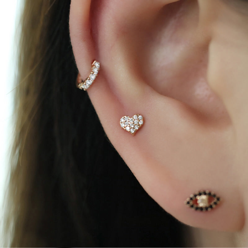 tiny diamond paved huggie hoop in cartilage piercing